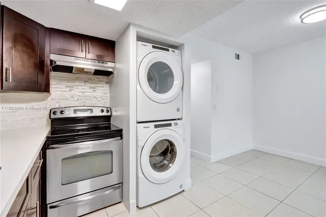 a kitchen with stove top oven and refrigerator