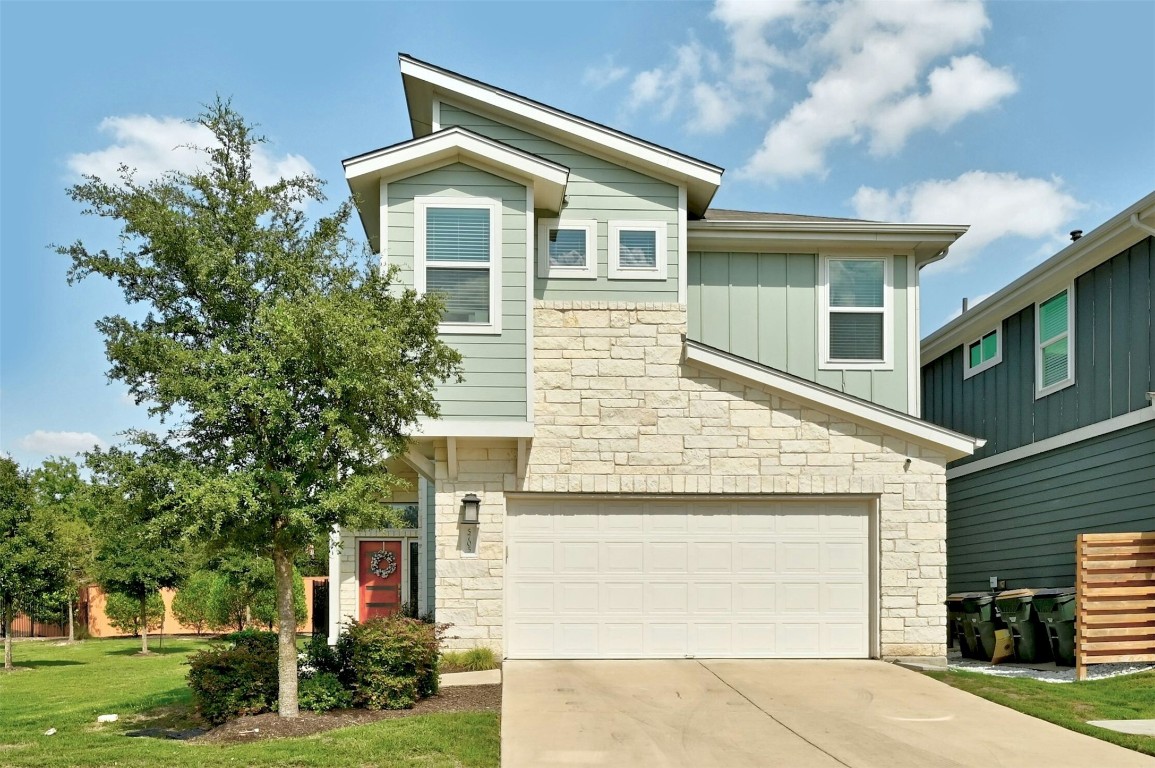 a front view of a house with a yard and garage