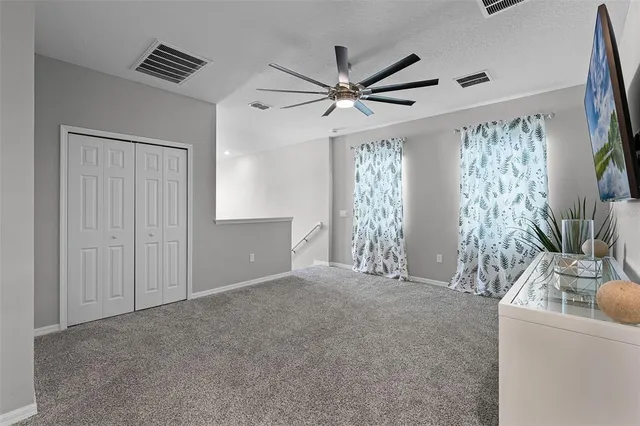 a view of an empty room with window and cabinet
