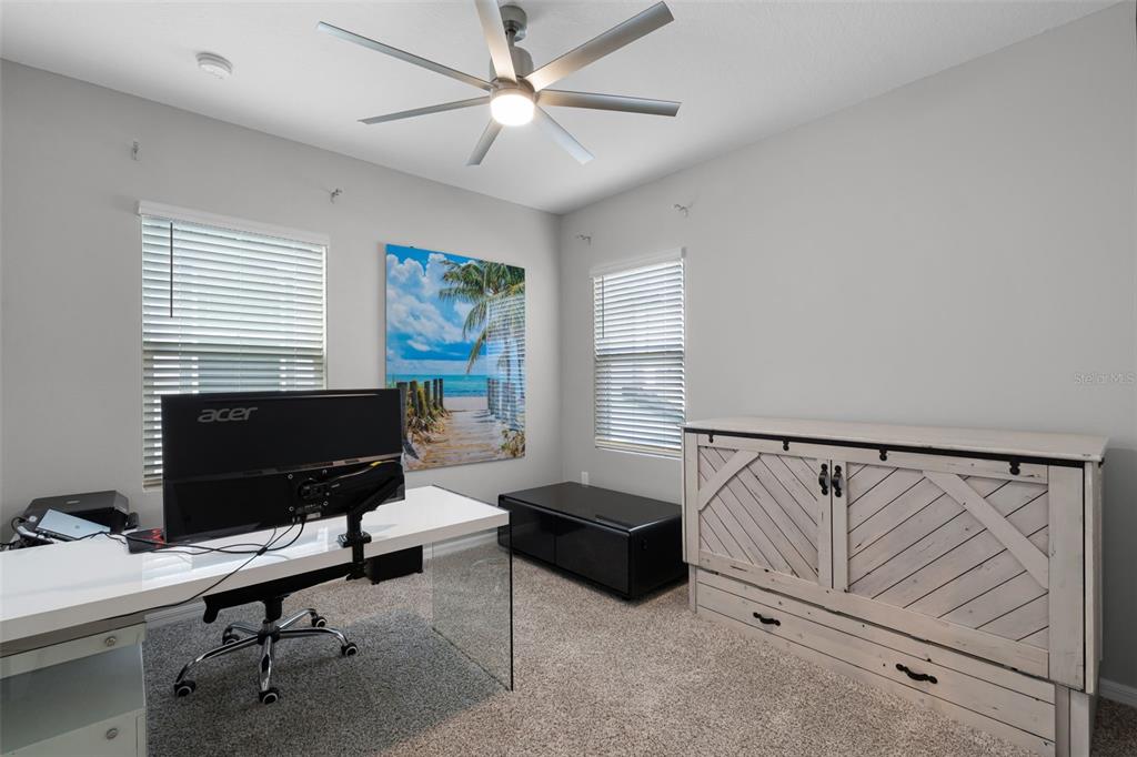 2286 Huntsman Rdg Road Minneola, FL 34715 - Photo 21 of 35 a living room with furniture and a flat screen tv