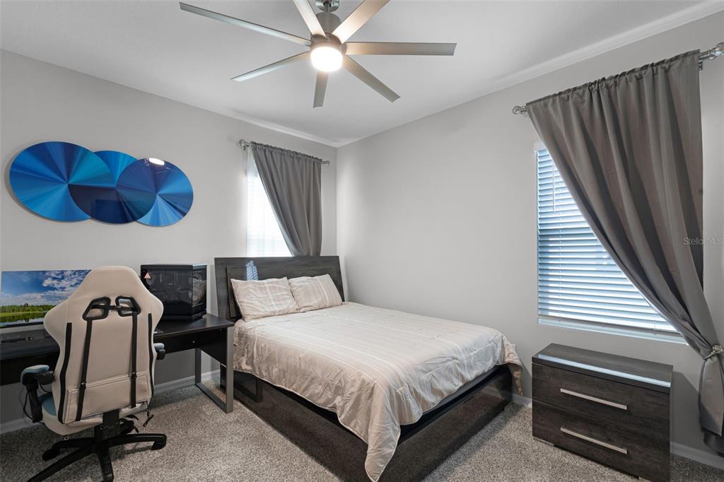 2286 Huntsman Rdg Road Minneola, FL 34715 - Photo 24 of 35 a bedroom with a bed and a chandelier