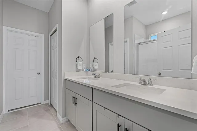 a bathroom with double sink and a mirror