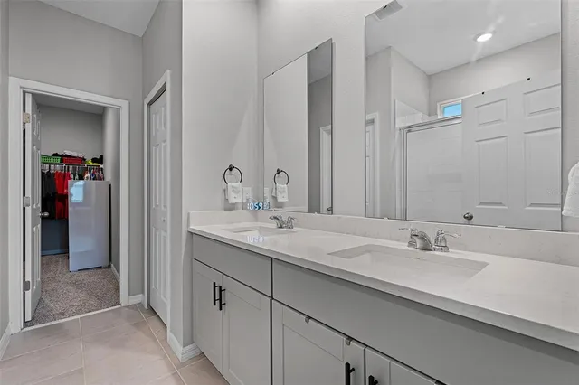 a bathroom with double sink and a mirror