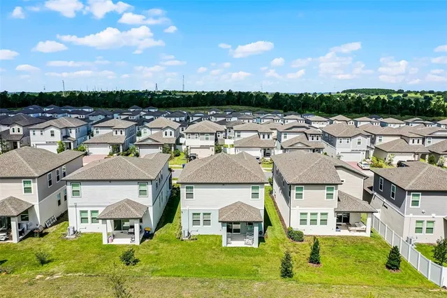 an aerial view of a residential apartment building with a yard