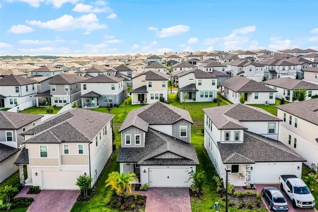 an aerial view of a houses with a city view