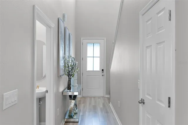 a view of a hallway with wooden floor and entryway