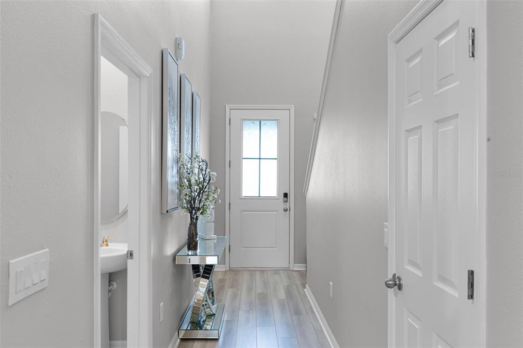 2286 Huntsman Rdg Road Minneola, FL 34715 - Photo 4 of 35 a view of a hallway with wooden floor and entryway