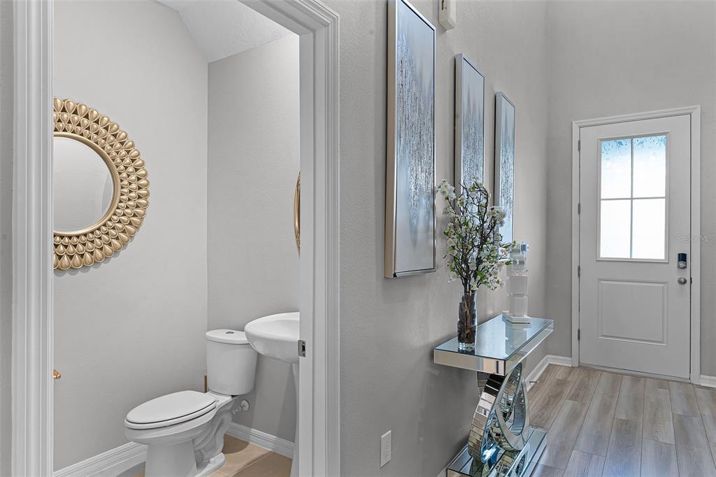 2286 Huntsman Rdg Road Minneola, FL 34715 - Photo 6 of 35 a bathroom with a toilet and a mirror