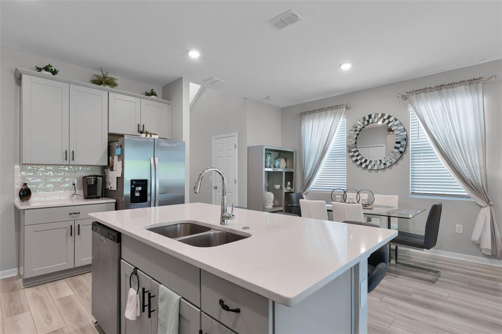 2286 Huntsman Rdg Road Minneola, FL 34715 - Photo 10 of 35 a kitchen with a table chairs sink and cabinets
