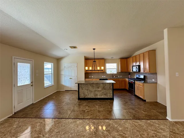 a large living room with kitchen island furniture and a kitchen view