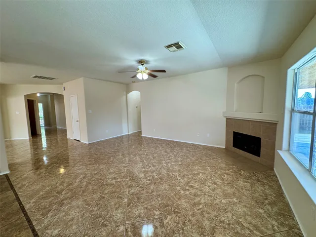 wooden floor in an empty room with a fireplace