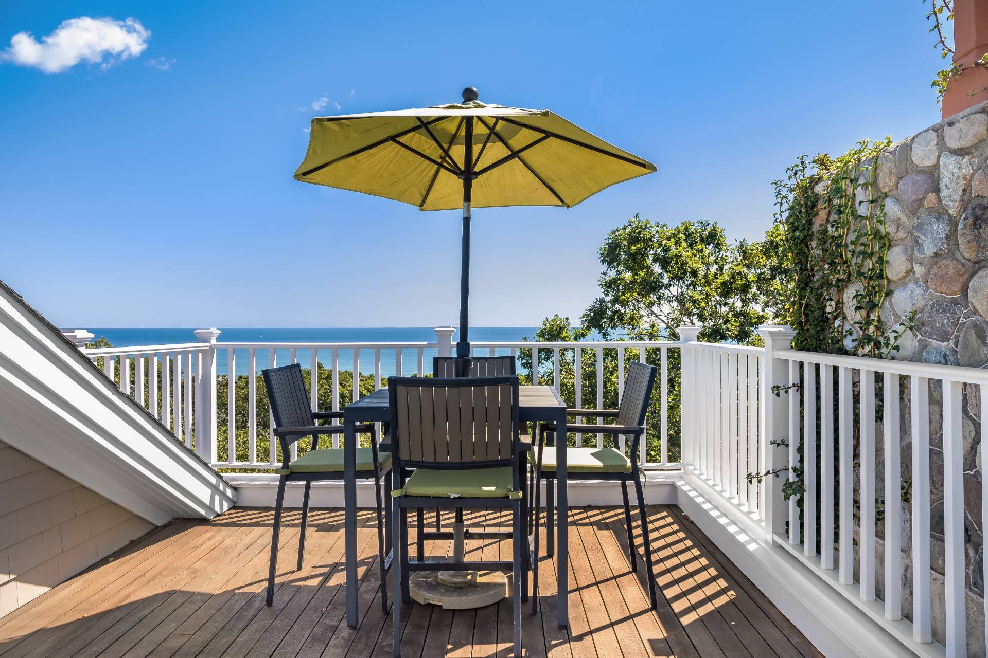 21 Tara Road Montauk, NY 11954 - Photo 31 of 37 a view of balcony with outdoor seating and wooden floor
