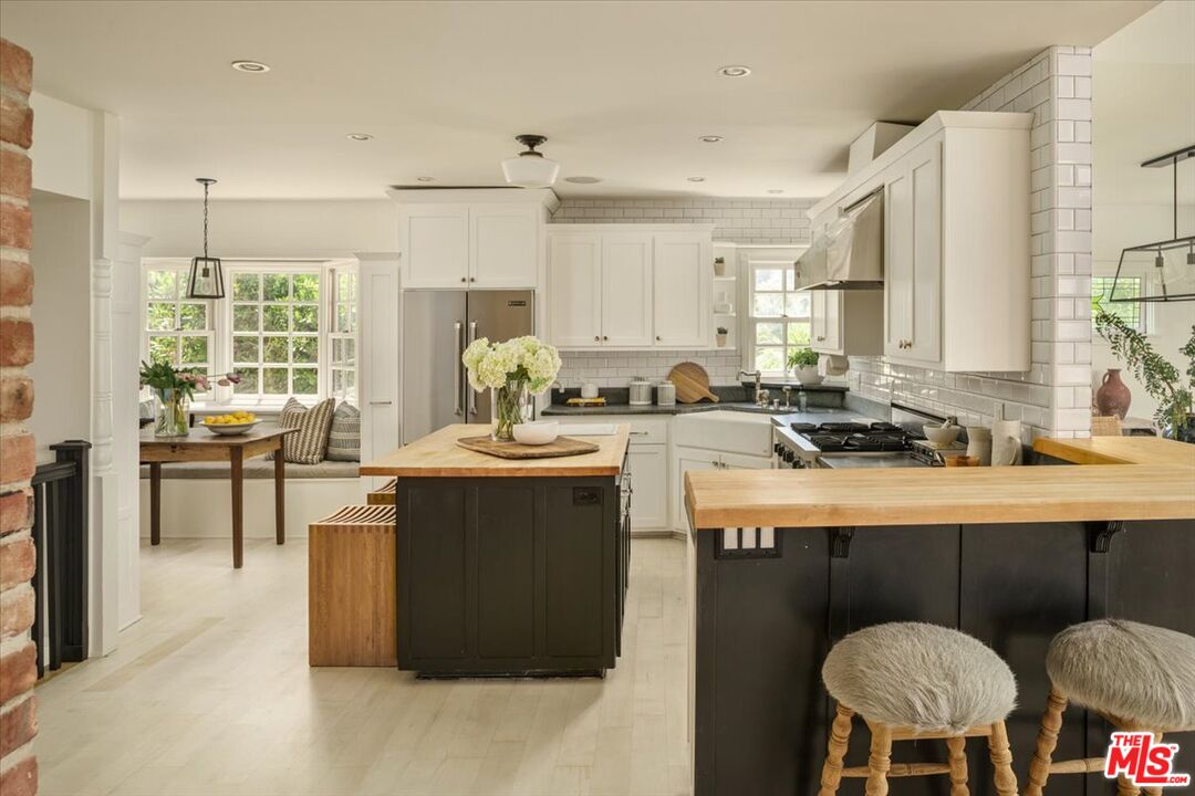 3983 Sunswept Drive Studio City, CA 91604 - Photo 14 of 53 a kitchen with a table chairs sink and cabinets