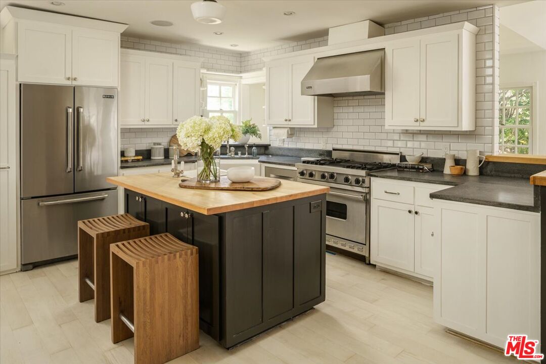 3983 Sunswept Drive Studio City, CA 91604 - Photo 15 of 53 a kitchen with a sink stove and refrigerator