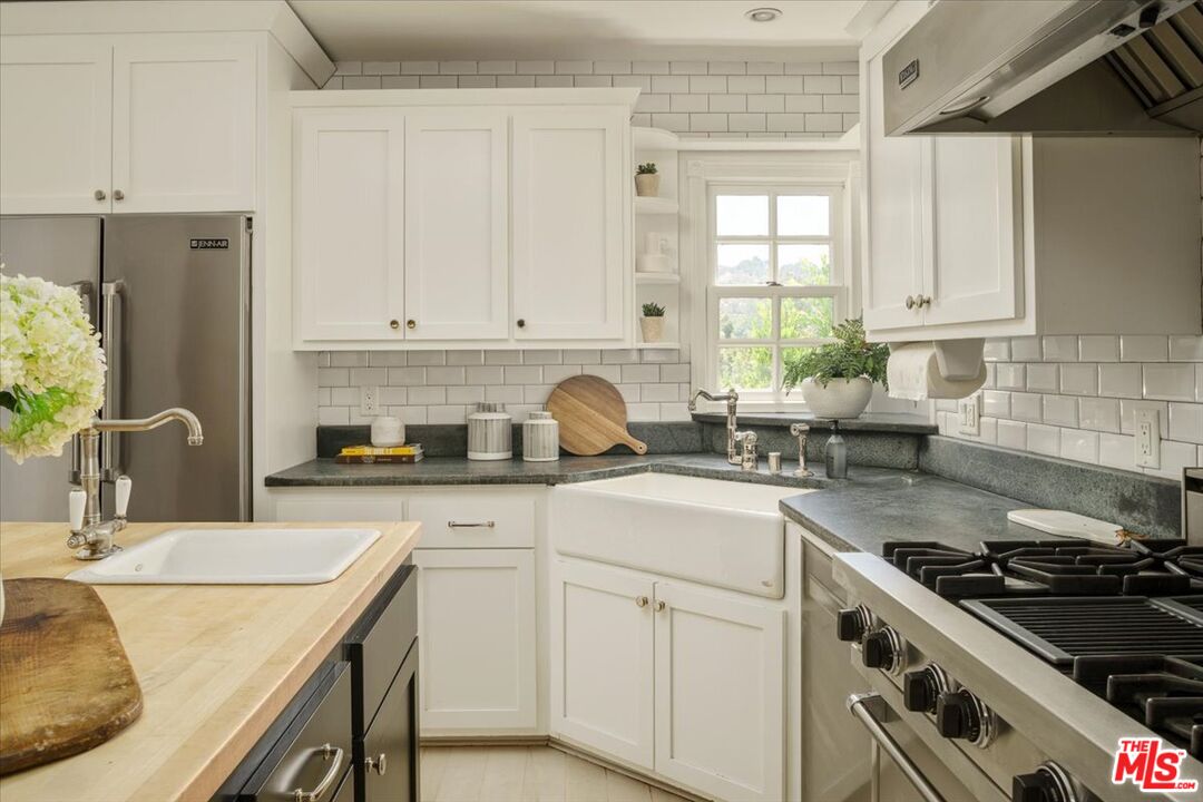 3983 Sunswept Drive Studio City, CA 91604 - Photo 19 of 53 a kitchen with stainless steel appliances granite countertop a sink stove and refrigerator