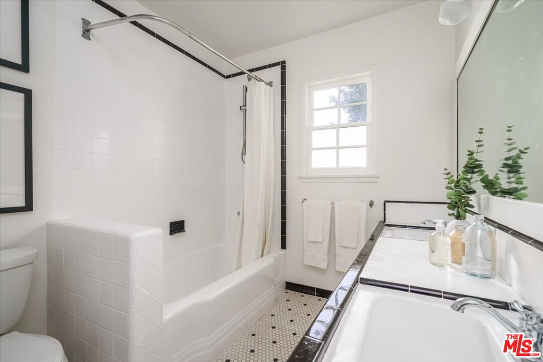 3983 Sunswept Drive Studio City, CA 91604 - Photo 26 of 53 a bathroom with a tub sink and mirror