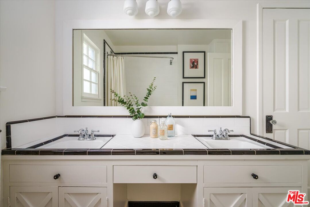 3983 Sunswept Drive Studio City, CA 91604 - Photo 27 of 53 a bathroom with a sink and a mirror