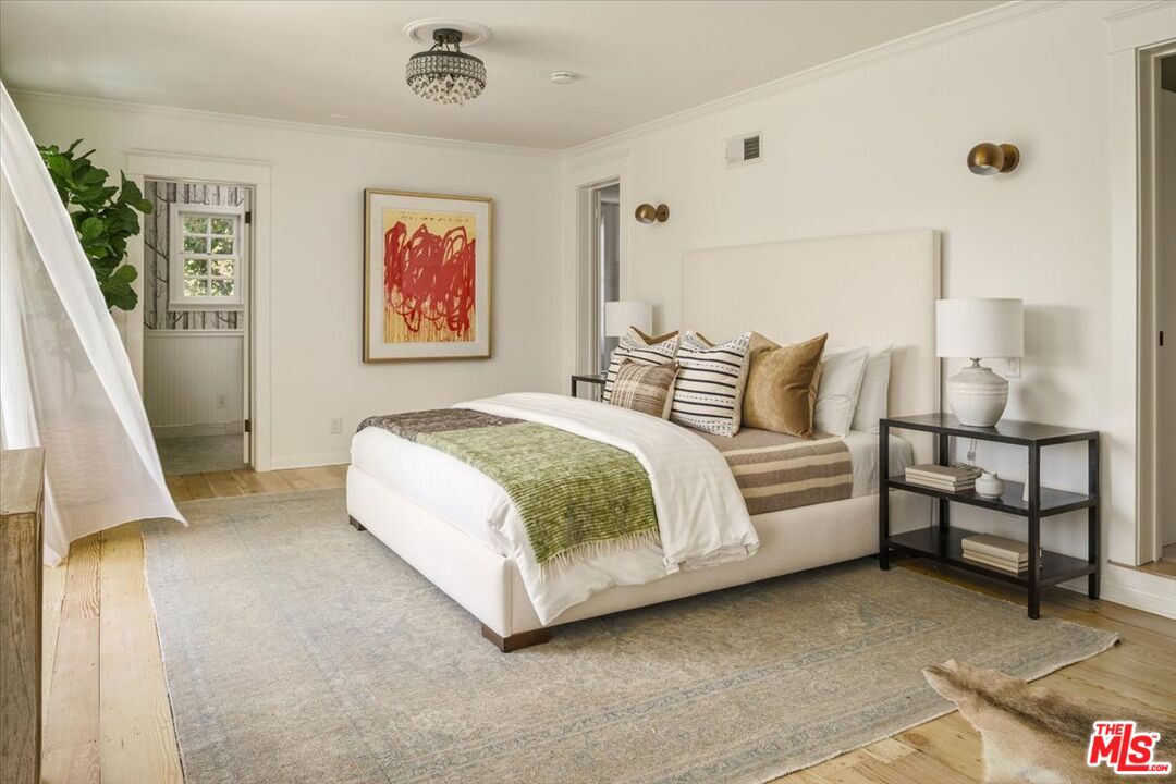 3983 Sunswept Drive Studio City, CA 91604 - Photo 31 of 53 a spacious bedroom with a bed and a couch