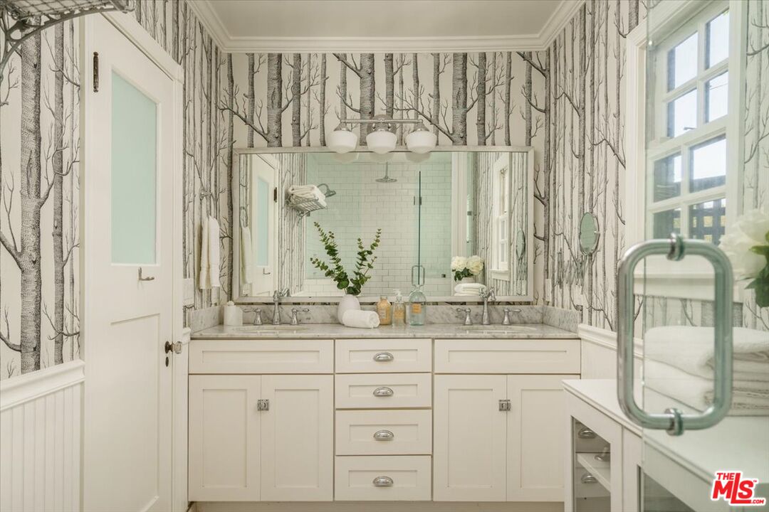 3983 Sunswept Drive Studio City, CA 91604 - Photo 37 of 53 a bathroom with a double vanity sink and a mirror