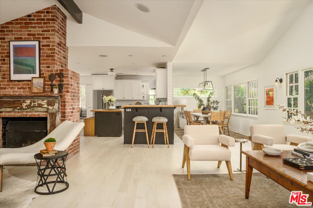3983 Sunswept Drive Studio City, CA 91604 - Photo 5 of 53 a living room with furniture a fireplace and a flat screen tv