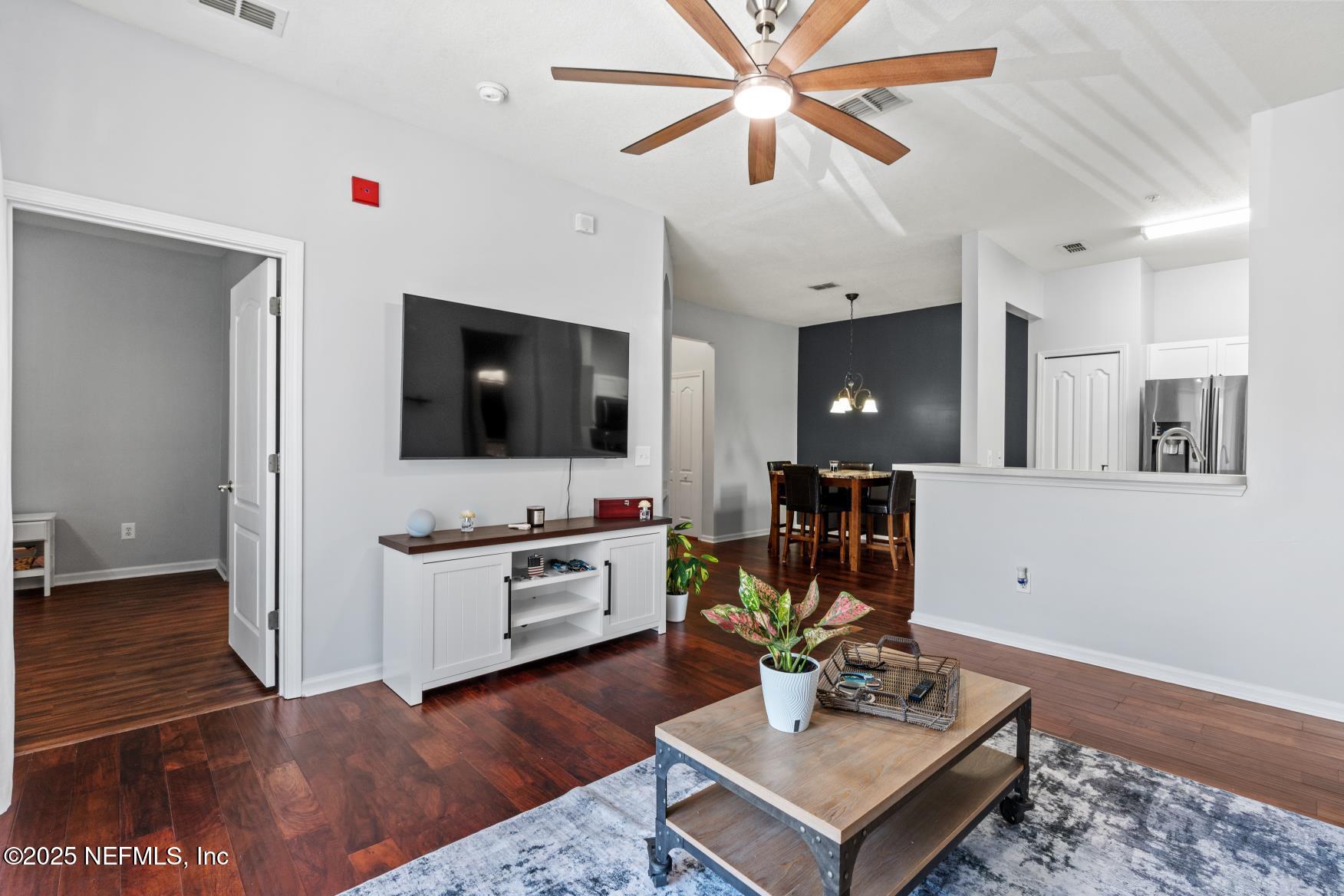 8601 Beach Boulevard, Unit 905 Jacksonville, FL 32216 - Photo 11 of 27 a living room with furniture and a flat screen tv