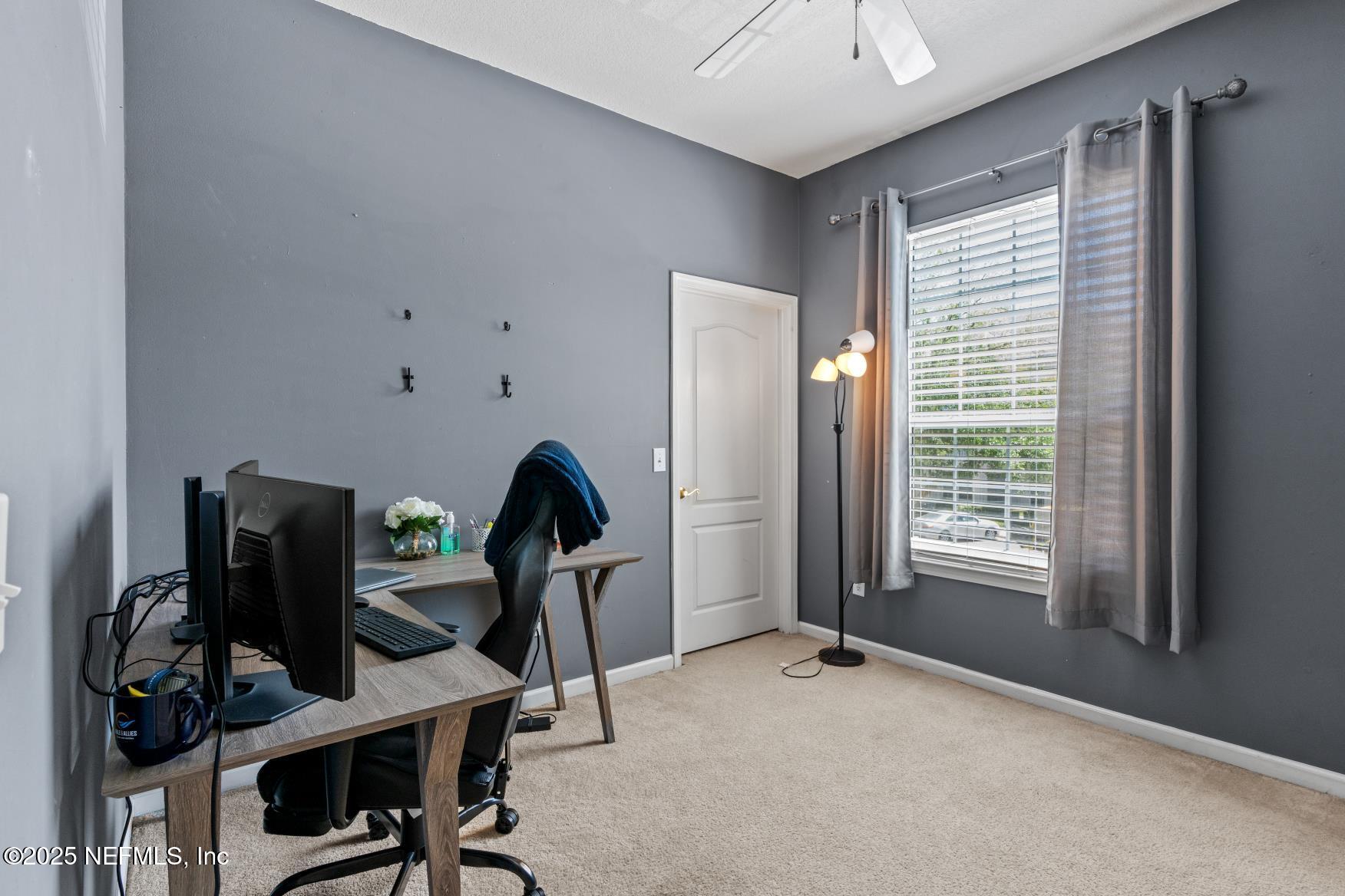 8601 Beach Boulevard, Unit 905 Jacksonville, FL 32216 - Photo 17 of 27 a view of a workspace with furniture and a window