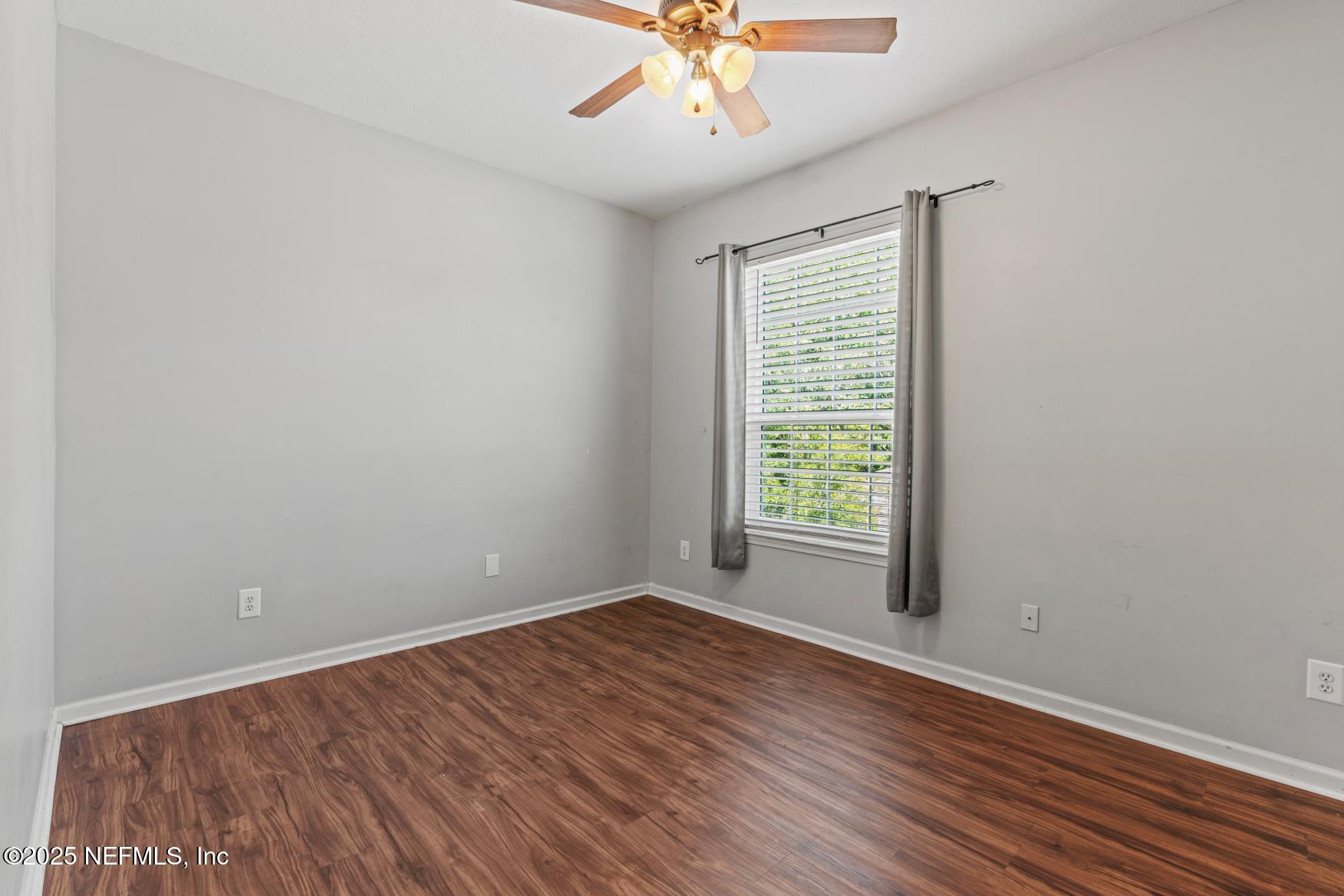 8601 Beach Boulevard, Unit 905 Jacksonville, FL 32216 - Photo 20 of 27 wooden floor in an empty room with a window