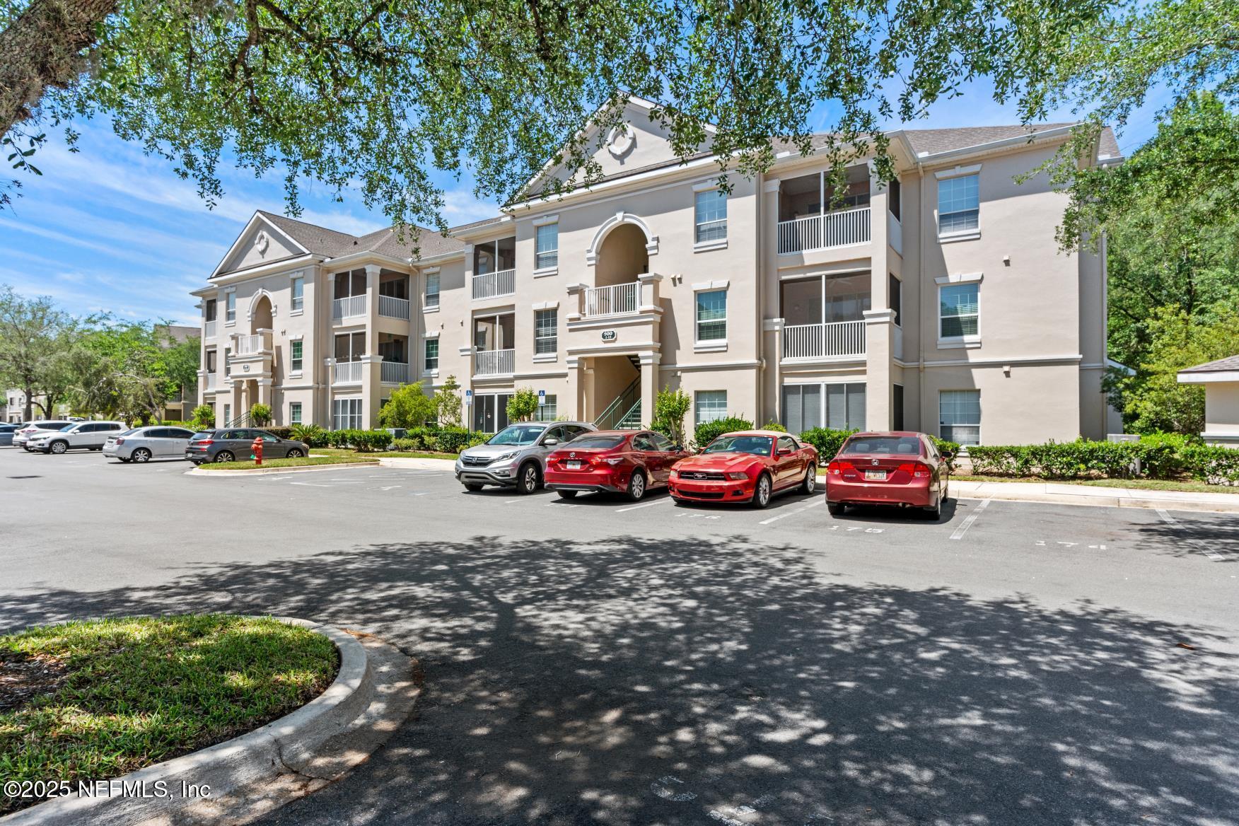 8601 Beach Boulevard, Unit 905 Jacksonville, FL 32216 - Photo 3 of 27 a couple of cars parked in front of a house