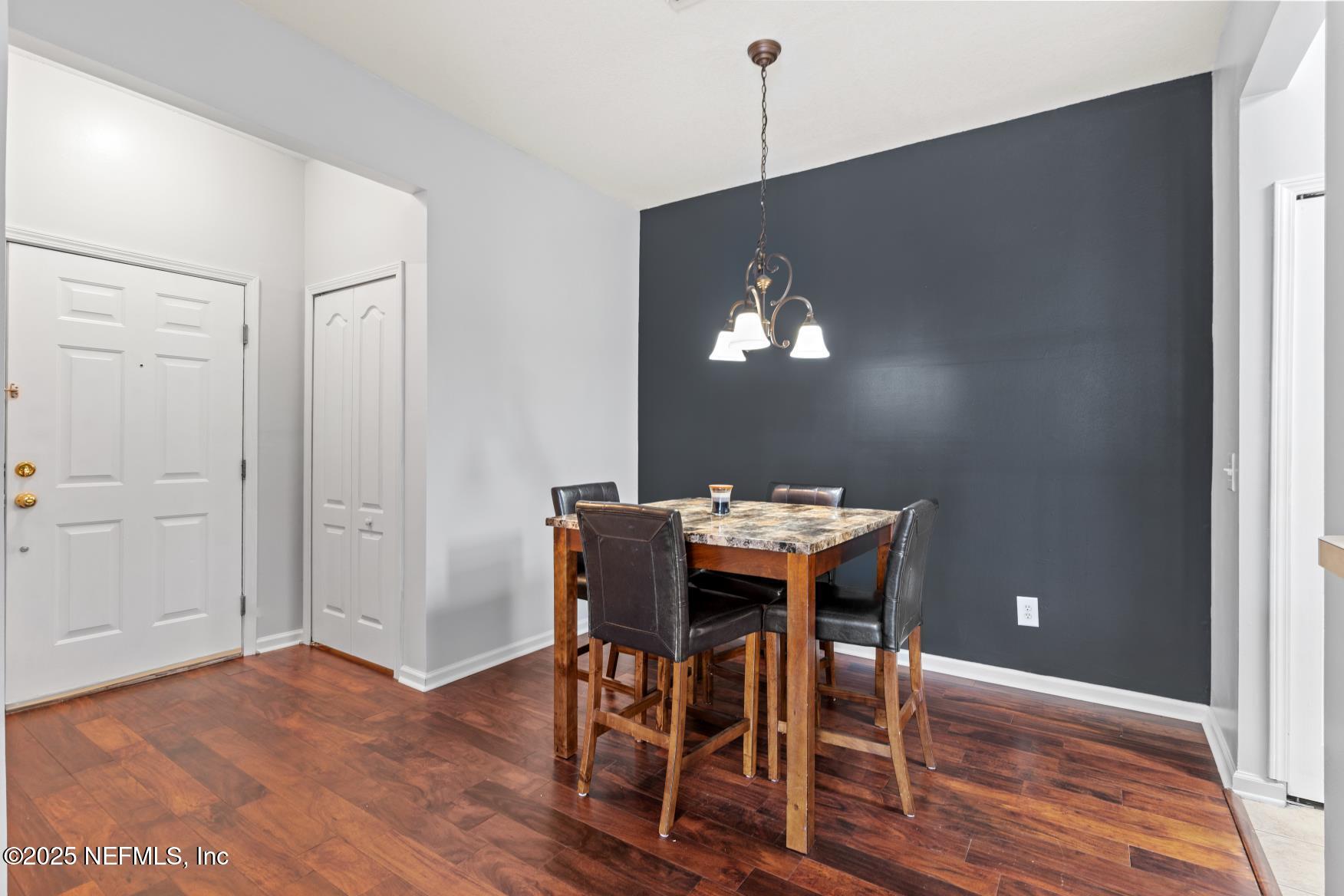 8601 Beach Boulevard, Unit 905 Jacksonville, FL 32216 - Photo 4 of 27 a view of a dining room with furniture and wooden floor