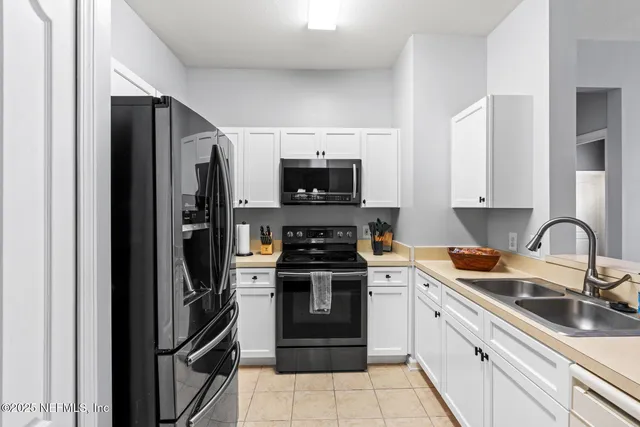 a kitchen with stainless steel appliances granite countertop a refrigerator stove and sink