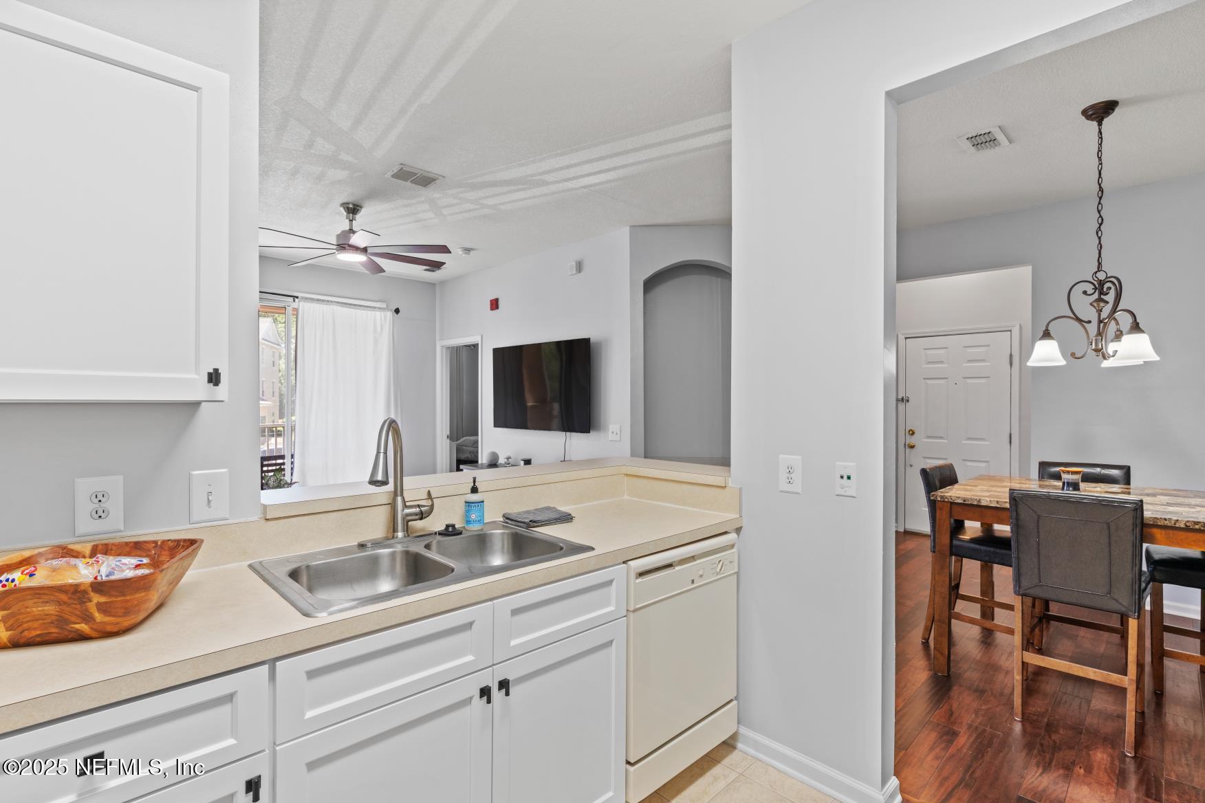 8601 Beach Boulevard, Unit 905 Jacksonville, FL 32216 - Photo 8 of 27 a kitchen with a sink and cabinets