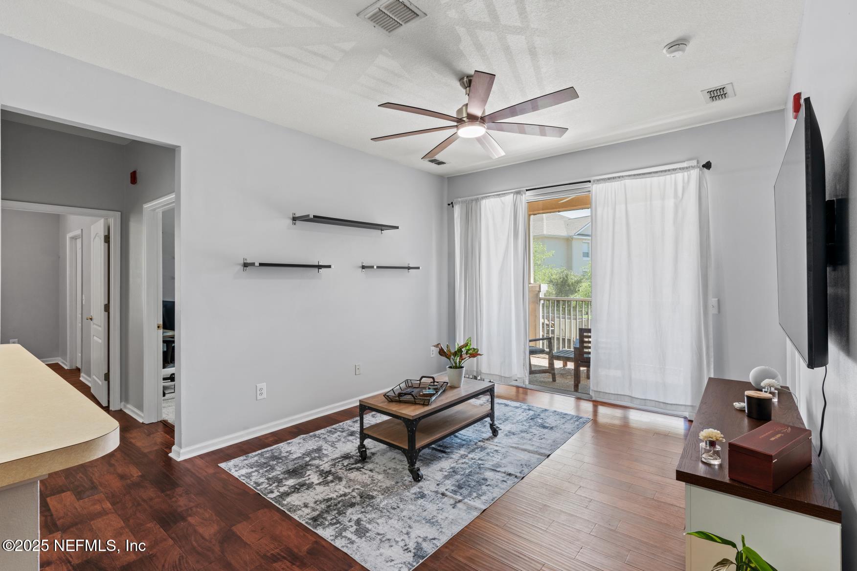 8601 Beach Boulevard, Unit 905 Jacksonville, FL 32216 - Photo 9 of 27 a living room with furniture and a window