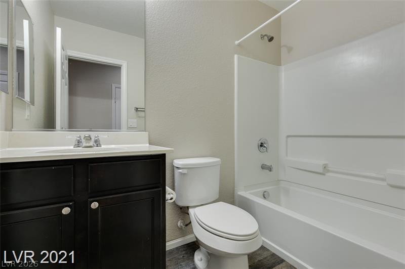 5475 Ordesa Valley Road Las Vegas, NV 89148 - Photo 21 of 35 A well-appointed bathroom features a modern vanity and a bright, clean shower-tub combination.