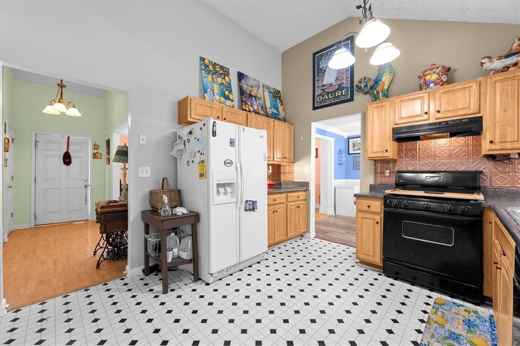 525 Michael Circle Monroe, GA 30655 - Photo 11 of 42 a kitchen with stainless steel appliances a refrigerator and a stove top oven