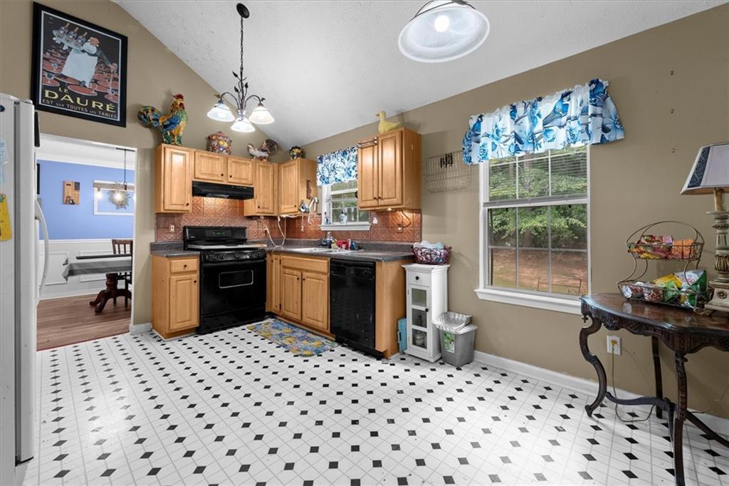 525 Michael Circle Monroe, GA 30655 - Photo 12 of 42 a kitchen with a sink window and cabinets