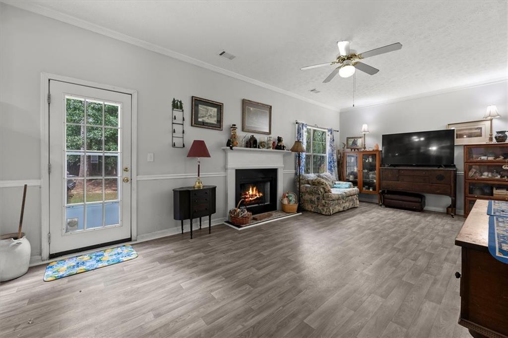 525 Michael Circle Monroe, GA 30655 - Photo 14 of 42 a living room with furniture a flat screen tv and a fireplace