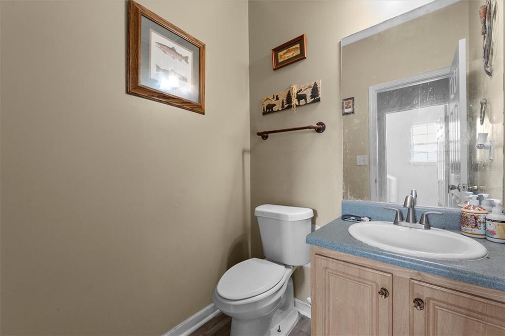 525 Michael Circle Monroe, GA 30655 - Photo 17 of 42 a bathroom with a toilet sink and mirror