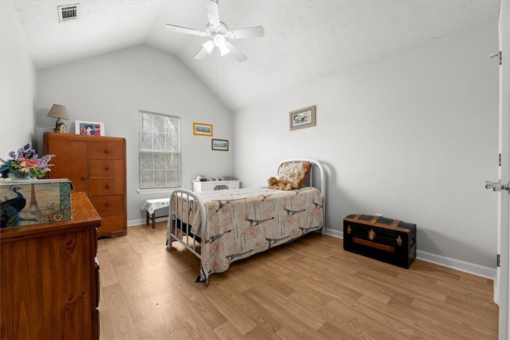 525 Michael Circle Monroe, GA 30655 - Photo 19 of 42 a bedroom with a bed and wooden floor