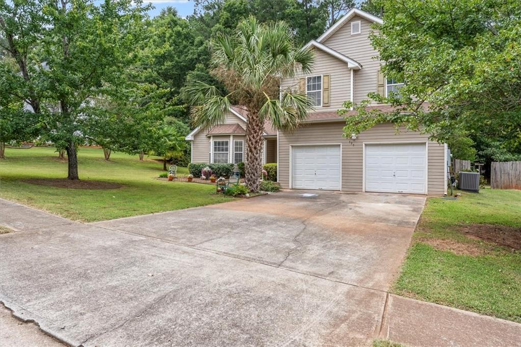 525 Michael Circle Monroe, GA 30655 - Photo 2 of 42 a front view of a house with a yard and garage