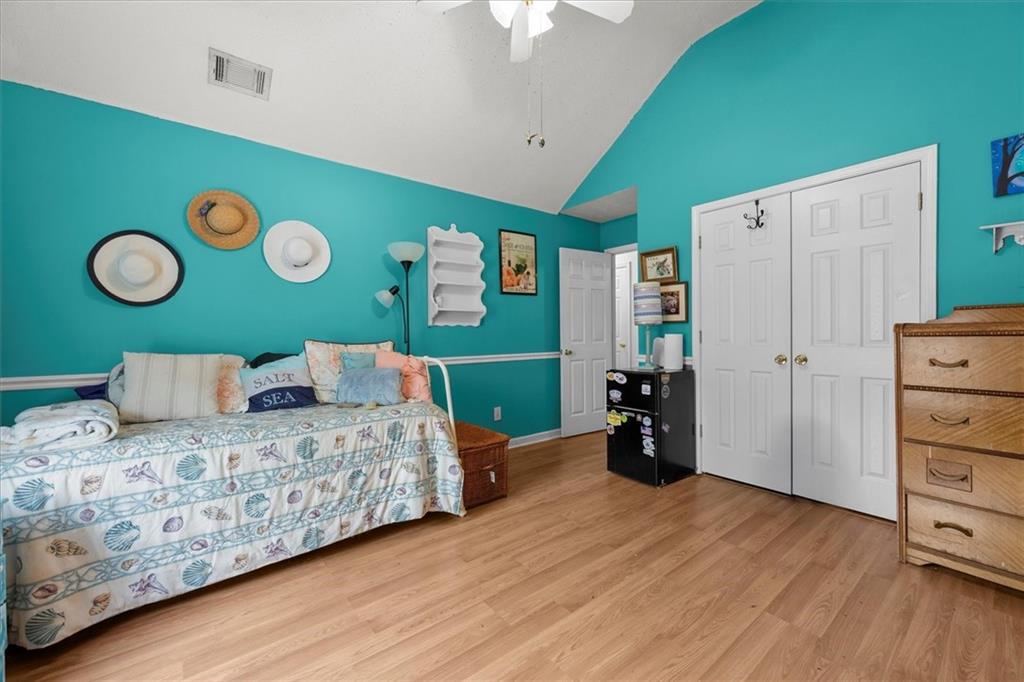 525 Michael Circle Monroe, GA 30655 - Photo 22 of 42 a bedroom with a bed and a chandelier