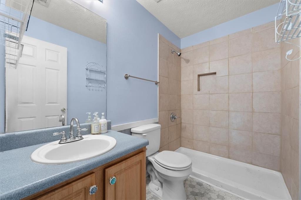 525 Michael Circle Monroe, GA 30655 - Photo 23 of 42 a bathroom with a sink a toilet and shower