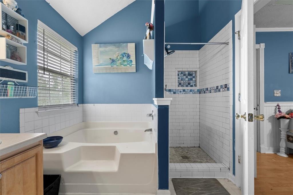 525 Michael Circle Monroe, GA 30655 - Photo 28 of 42 a bathroom with a bathtub and a shower