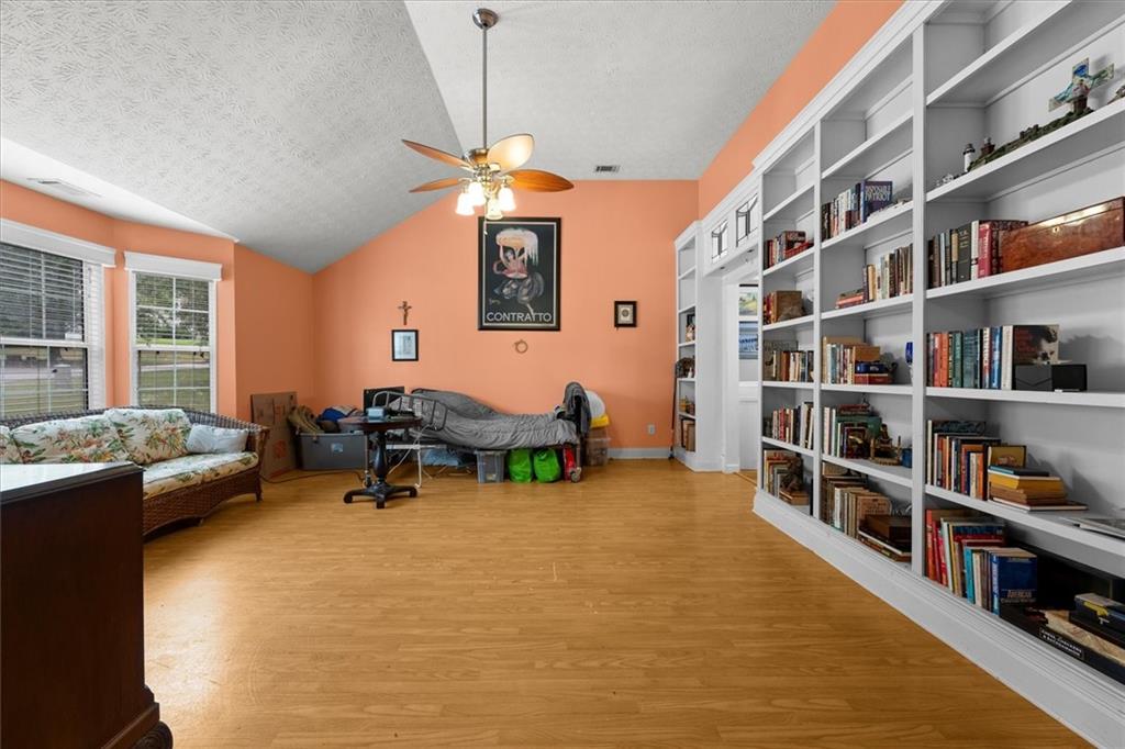 525 Michael Circle Monroe, GA 30655 - Photo 6 of 42 a living room with furniture cabinets and a chandelier
