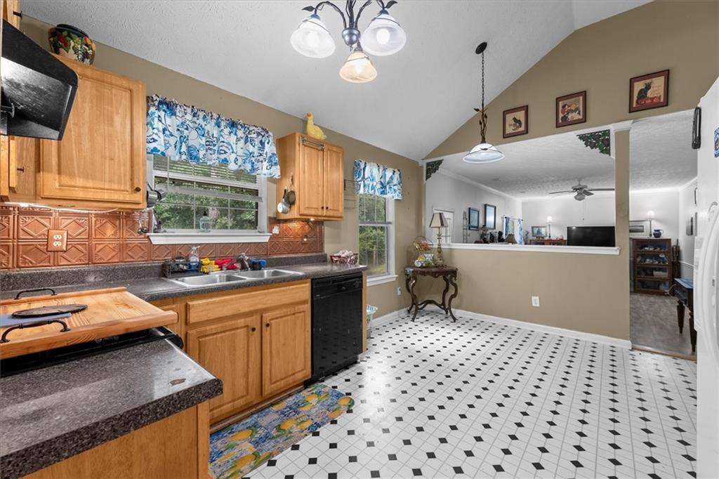 525 Michael Circle Monroe, GA 30655 - Photo 10 of 42 a kitchen with a sink a stove a microwave and cabinets