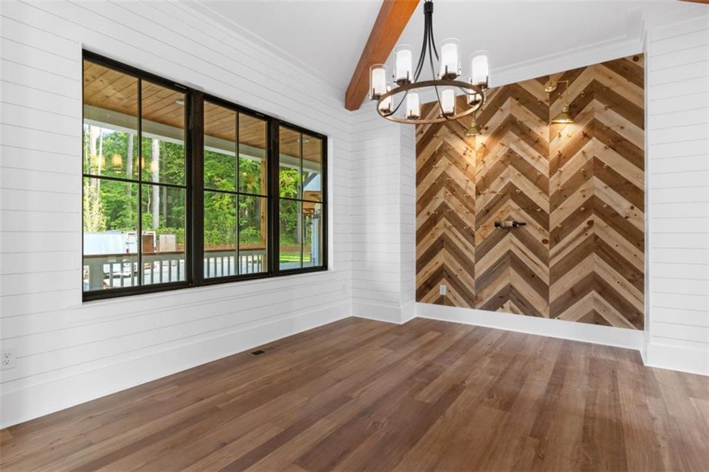 3 Cox Road Roswell, GA 30075 - Photo 11 of 38 a view of an empty room with a window and wooden floor