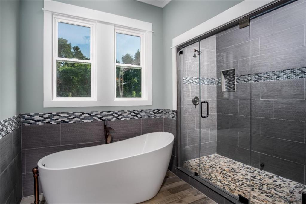 3 Cox Road Roswell, GA 30075 - Photo 21 of 38 a bathroom with a bathtub and shower