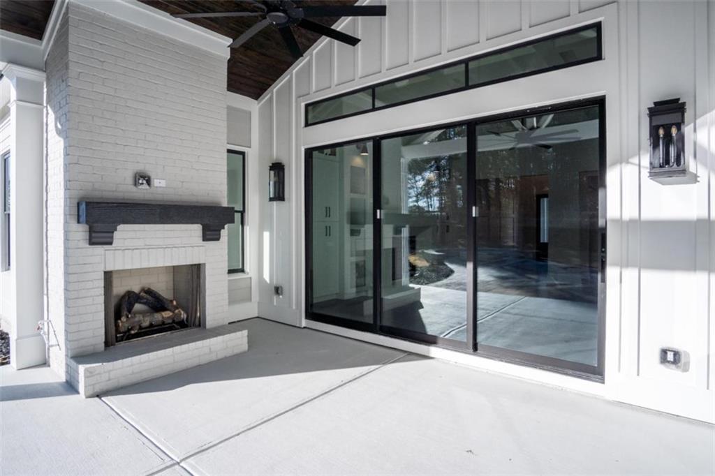 3 Cox Road Roswell, GA 30075 - Photo 6 of 37 a living room with a fireplace and a floor to ceiling window