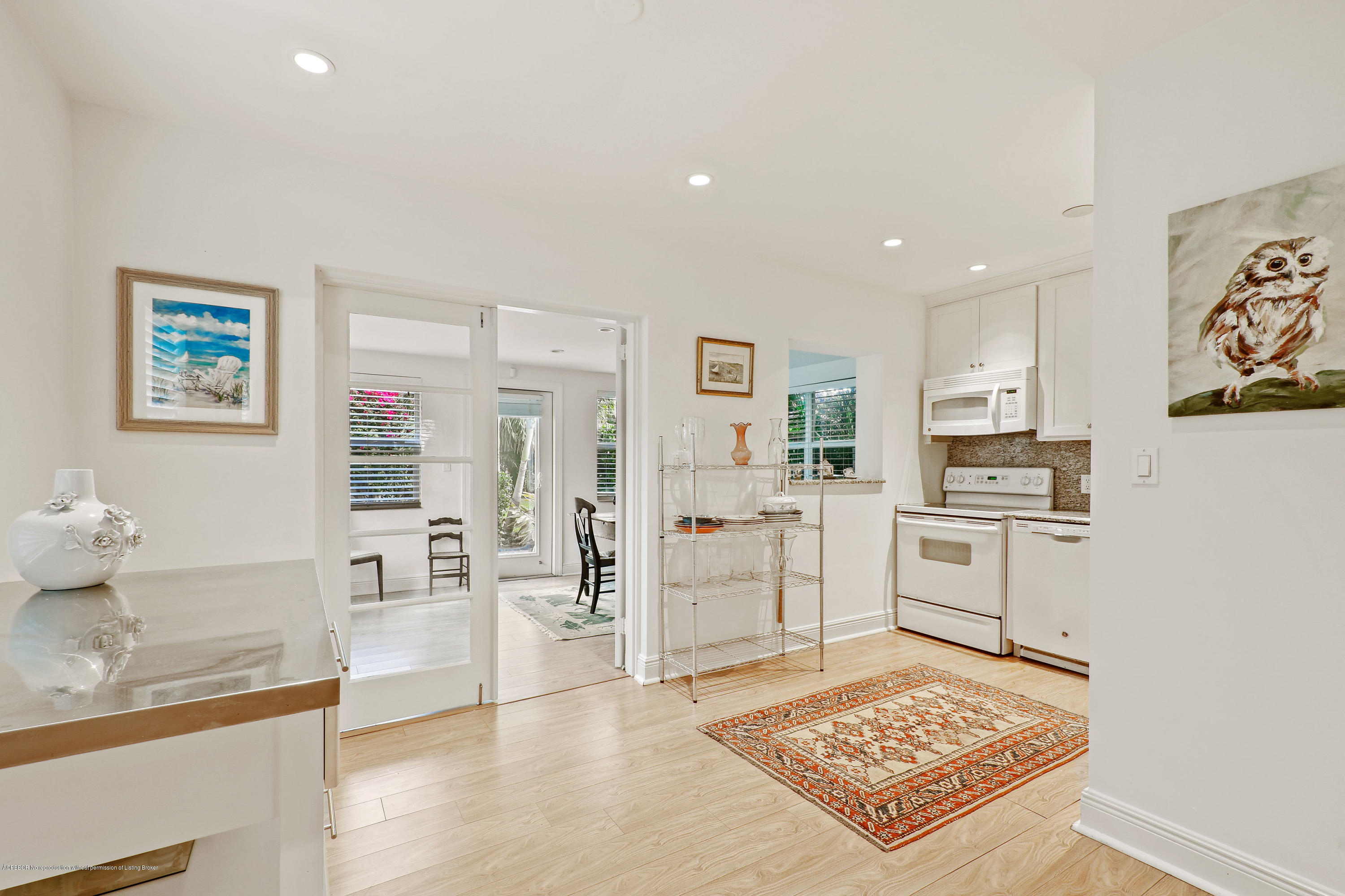341 Murray Road West Palm Beach, FL 33405 - Photo 8 of 25 a kitchen with white cabinets and stainless steel appliances