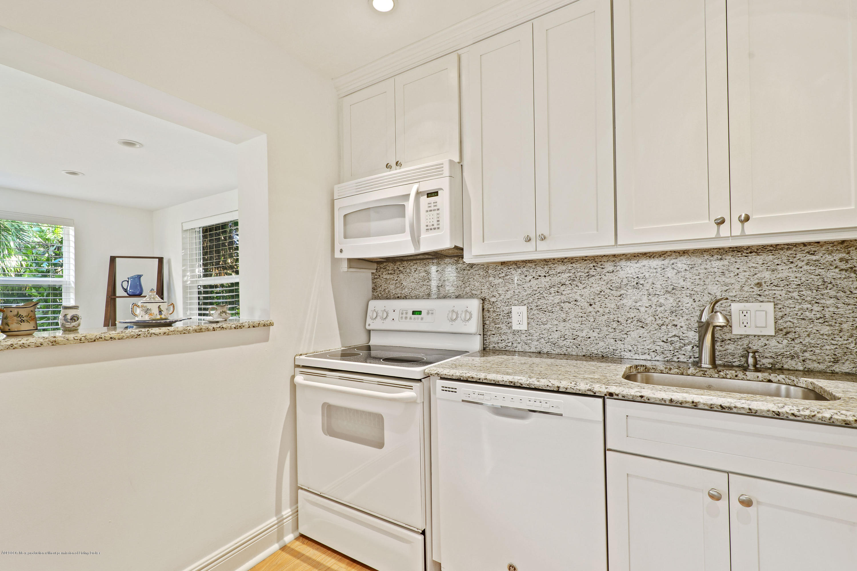 341 Murray Road West Palm Beach, FL 33405 - Photo 10 of 25 a kitchen with granite countertop white cabinets and white appliances
