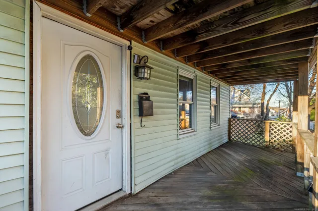 a view of a porch with wooden floors